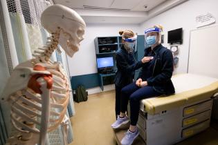 Two Physician Assistant students practice taking vital signs in the Clinical Skills Simulation Center (SimClin) at the Tufts University School of Medicine